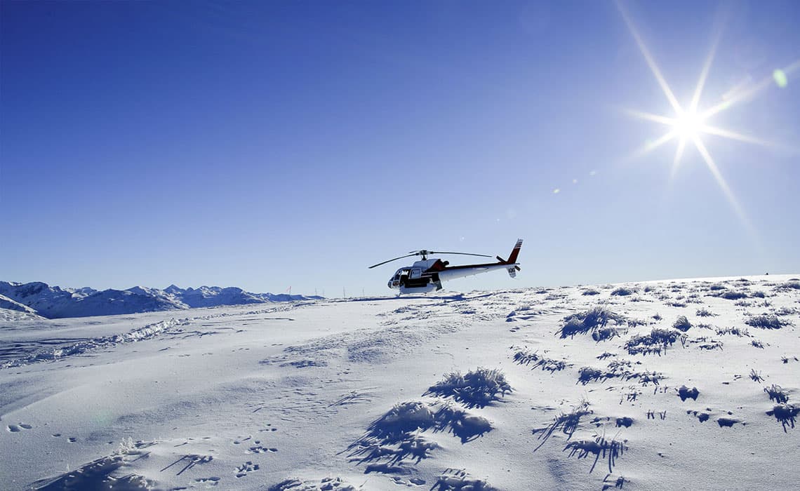 Modern Airbus Helicopter Flies to Queenstown Snowmobiles
